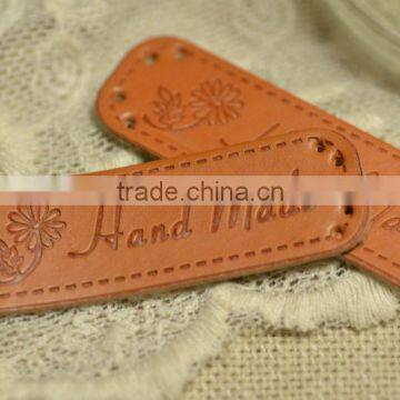 Customized pu brand logo embossed leather label for garments