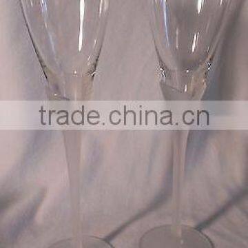 Two clear glass champagne flutes with twisted stem