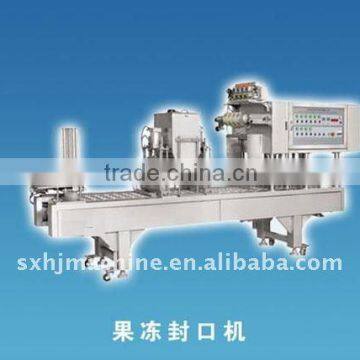 Disposable plastic cup filling/sealing machine