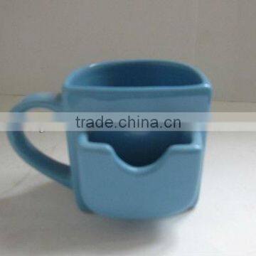 colored stoneware coffee mug with biscuit holder