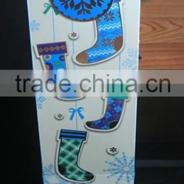 Handmade paper bottle bag with socks and snow