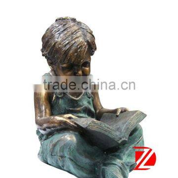 Bronze garden reading boy statue sitting in yard