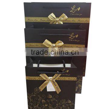 Gift paper bag with ribbon bow tie