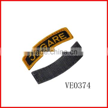 Clothing embroidery brand cuff tabs