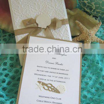 Elegant white beach style embossed accent wedding invitation with brown ribbons & seashell decoration for wedding