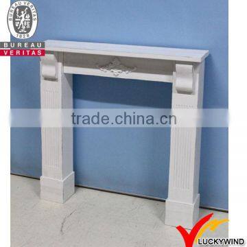 White antique wooden fireplace mantel