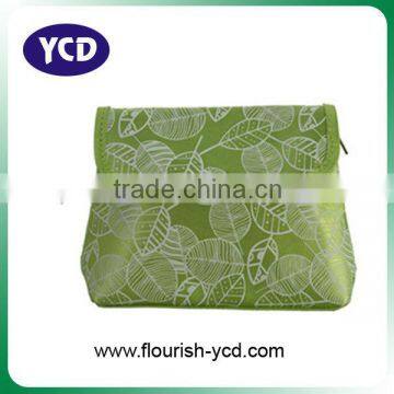 green satin cosmetic bag with printed leaves