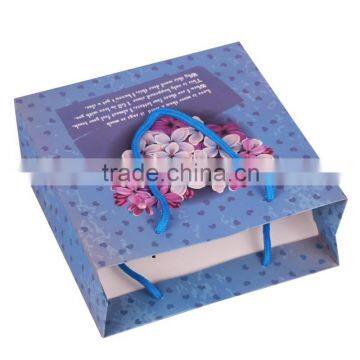 light blue paper bag with flower heart shape