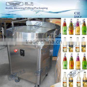 Rotary bottle feeding table with frequency changer and adjustable support
