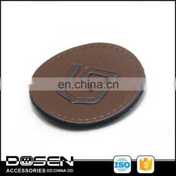 Wholesale factory direct custom private brand brown leather patches,Round shape leather label for jeans.