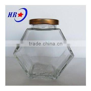 holding 500g Honey glass jar with golden lid