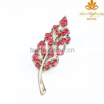 Gold leaf alloy brooches with red rhinestones