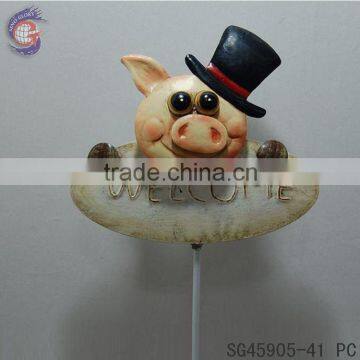 pig iron stake decor in garden with welcome sign