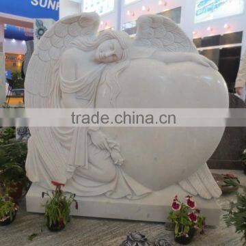 White marble angel with heart headstones