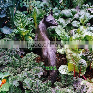 Bronze fox animal statue in grassland