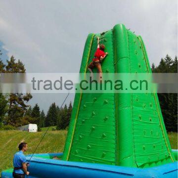 Giant green inflatable rock climbing wall