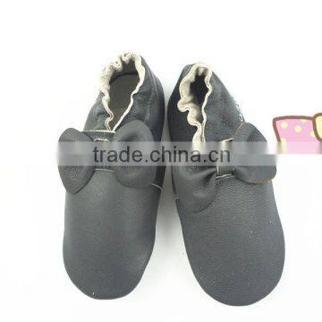 designer decorating baby leather shoes