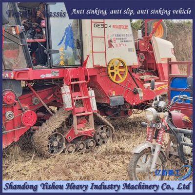 Triangle track wheel harvesting wheat in muddy terrain during rainy season to prevent sinking