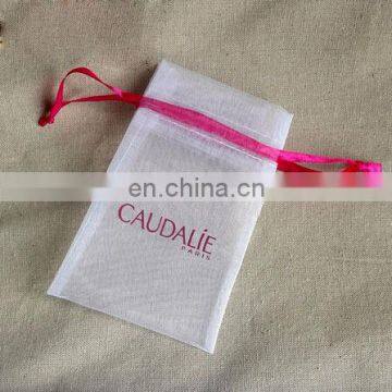 White organza bag with red ribbon