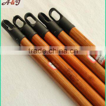 varnished wooden broom handle with long hanger