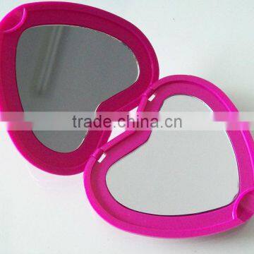 Cosmetic mirror with hair brush