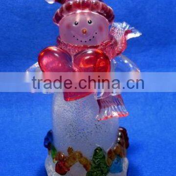 Holding a red heart acrylic snowman with LED Light