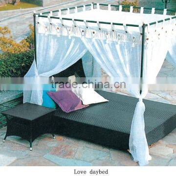 Elegant outdoor wicker daybed with mosquito nets and supports rod