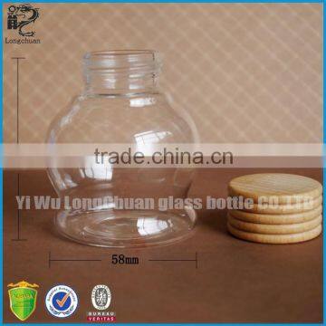 clear round shaped glass bath salt bottle with sealing wood screw cap