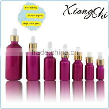 pink coated glass essential oil bottle with gold dropper