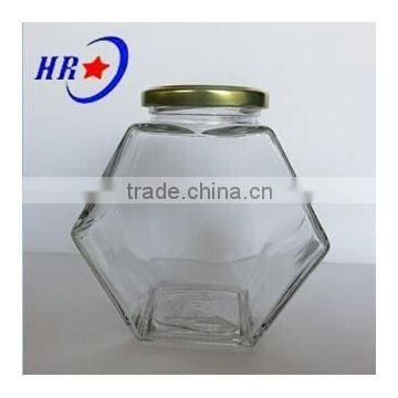 holding 750g Honey glass jar with golden lid