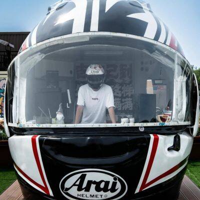 The large-scale outdoor stainless steel artistic motorcycle helmet and coffee house sculpture are handcrafted using electroplating technology.