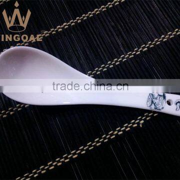 white ceramic spoon with decal