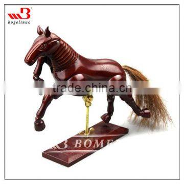 wooden horse artist manikin with red paint outside