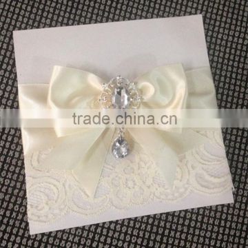 Hot sale elegant & personalized white lace wedding invitations with ivory ribbons & rhinestone brooches