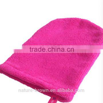 Facial in pink exfoliating mitts to clean the dead skin