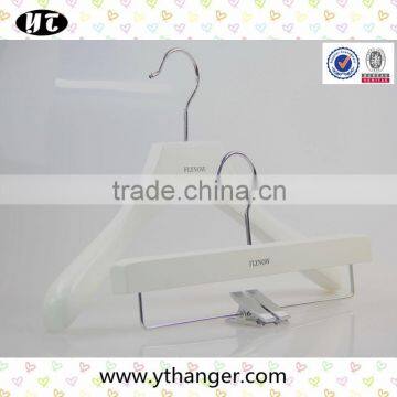 white wooden hanger and pants hanger for luxury garment