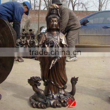 bronze kuan yin statue standing on dragon sculpture