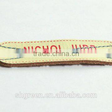 Silk screen printing branded leather tags with metal eyelets