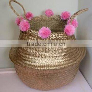 High quality best selling eco-friendly Gold seagrass storage basket with pink pompoms from Vietnam