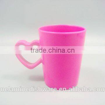 Pink solid color water cup with cute design and handle