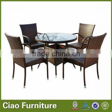 The outdoor bistro table and stackable rattan chairs