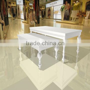 white or custum made wooden clothes display set tables