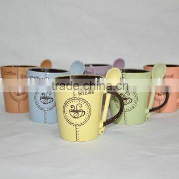 Different color mug with spoon