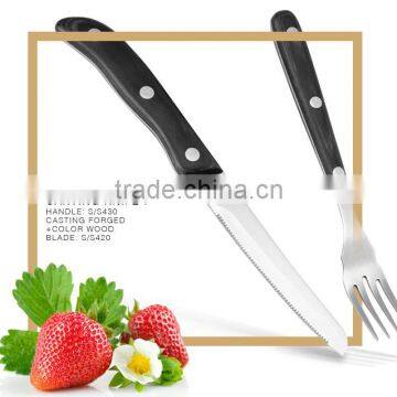 color wood handle steak knife and fork