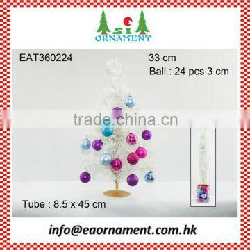 Set of decorative hanging balls and white artificial christmas tree