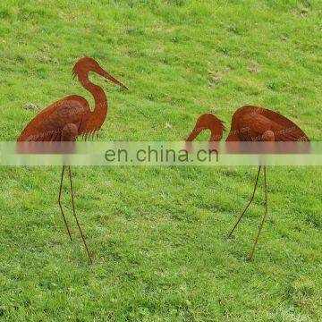 Abstract rustic metal crane garden sculpture in corten